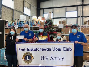 Ron Lindemann and fellow members of the Fort Saskatchewan Lions Club toured the new Food Bank facility and presented the local organization with a donation of $850. Photo Supplied.