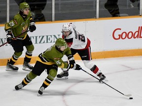 Anthony Romani, seen playing the puck against the Ottawa 67's as Nic Sima monitors the play, is among North Bay Battalion forwards vying for ice time in two road games this weekend. The Troops visit the Hamilton Bulldogs on Friday night.
Sean Ryan Photo