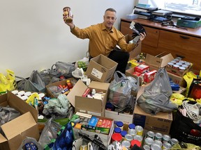 Nipissing University President and Vice-Chancellor Kevin Wamsley shows the bags of food donations that will be put into holiday baskets for Nipissing University students who access the school food bank. Feed Ontario released a report that shows an increase of 10 per cent of people who accessed emergency food support last year. Local charities and organizations have seen increases much higher.