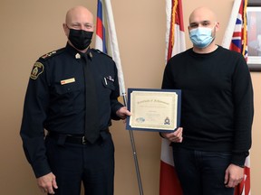 Greater Sudbury Police Chief Paul Pedersen presents a Chief’s Nickel Award to 911 communicator Kevin D’Aoust for his role in saving the life of a woman on Ramsey Lake.