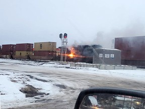 Smoke and flames can be seen coming from a locomotive on a train passing through Spruce Grove on Sunday, Nov. 28. Fire crews from Parkland County were called and quickly put out the fire.