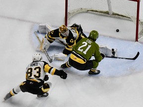 Brandon Coe of the North Bay Battalion puts the puck past Hamilton Bulldogs goaltender Marco Costantini in the first period of their Ontario Hockey League game Friday night at FirstOntario Place as Chandler Romeo engages in a futile pursuit. The Troops visit the Niagara IceDogs on Saturday night.
Sean Ryan Photo