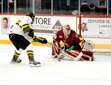 Timmins Rock goalie Gavin McCarthy gets just enough of this shot off the stick of Powassan Voodoos forward Brett Richardson to deflect the puck just wide of the post during the second period of Sunday afternoon’s NOJHL contest at the McIntyre Arena. The Rock scored early and often en route to a 7-2 win that allowed them to secure sole possession of top spot in the NOJHL’s overall and East Division standings. THOMAS PERRY/THE DAILY PRESS