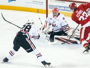 Niagara IceDogs goaltender Tucker Tynan defends the net against Soo Greyhounds forward Rory Kerins during OHL action in St. Catharines. On Monday afternoon the Greyhounds traded for Tynan for two OHL draft picks.