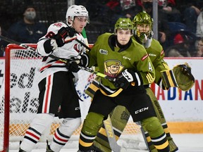 Paul Christopoulos of the North Bay Battalion covers Liam Van Loon of the Niagara IceDogs as goaltender Dom DiVincentiis keeps an eye out in Ontario Hockey League action Saturday night at St. Catharines. The Troops host the Sault Ste. Marie Greyhounds on Thursday night.
Sean Ryan Photo