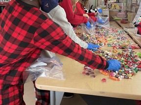 Micaiah Ansah, Zak Marshall, Layne Svendsen, Savera Shergill, Ashlynn Hampton of Kim Lee's class get to work filling treatbags that they will sell at the Herons Crossing Christmas Market in support of Bethany Airdrie.
