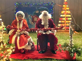 Santa and Mrs. Claus pose in front of the arena, ready for kids to visit and get photos after the parade. Victoria Acres