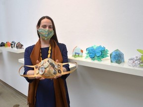 Tom Thomson Art Gallery Curator of Public Projects and Education Heather McLeese holds a mask designed and created by John Diefenbaker senior arts student Zanne Stassen. The mask is part of a youth-focused art initiative with the gallery and artist Don Kwan called Emerging Artists Unmasked.