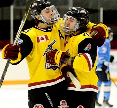 Timmins Rock forward Tyler Gilberds, left, hugs teammate Riley Brousseau while celebrating his first-period goal during Sunday afternoon’s NOJHL game at the McIntyre Arena. Brousseau’s 12th goal of the season gave the Rock a 7-1 lead over the Cochrane Crunch in a game they would go on to win 10-4, sweeping both halves of their home-and-home series. THOMAS PERRY/THE DAILY PRESS