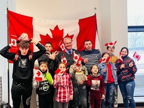 Ten members of the Al Abrahim family who came to Port Elgin as Syrian refugees six years ago, took their Oaths of Citizenship and became Canadian citizens during a virtual ceremony Dec. 8. The family participated in the momentous and joyful ceremony from the boardroom at the Port Elgin police station, and offered thanks to Pat O'Connor (centre), riding rep for Huron Bruce MP Ben Lobb who helped make it happen. [Family photo]