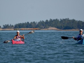 Kayakers paddle off the coast of Philip Edward Island near Killarney. The province has proposed the transfer of Philip Edward and other surrounding Crown islands to the Wiikwemkoong First Nation as part of a land claim settlement.