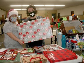 The Angel Project is returning to brighten the holidays for those in need. Pictured are volunteer Kathleen Binns, left, and Noah's Ark/Community Table volunteer co-ordinator Andrea Loohuizen as they prepare food hampers in 2020. Scott Nixon