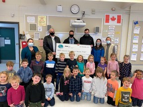 Representatives from the South Bruce Community Liaison Committee (CLC), the Nuclear Waste
Management Organization (NWMO), and Hillcrest Central School met for a cheque presentation in Teeswater on December 9th. From L-R, Teacher Courtney Alexander, CLC Chair Jim Gowland, NWMO Engagement Associate Paul McGrath, CLC Member Justin McKague, CLC Project Coordinator Morgan Hickling, Principal Stephanie Bouchard stand in front of one of the tech walls, joined by kindergarten students. (Students in JK/SK not required to
wear masks in Ontario schools)