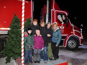 Sisters Kodie Daffurn, Alex Roth, Dallas Nawrot and Lacey Nawrot and kids Sawyer and Charlie had a socially distanced photo with Santa taken at the Coca-Cola Holiday Truck Monday night. Fields manager Lacey Nawrot said the business hosted the truck during its first tour across Canada.