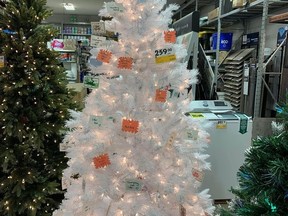 The Humane Society's Christmas Tree with donation requests located at Rona.