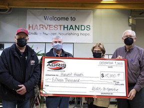 John Nooyen, AGRIS Co-operative board president, left, and Jim Anderson, AGRIS ownership committee chair, middle-left, present a donation to Harvest Hands founders Jacintha and Jim Collins. The $15,000 contribution will be put towards food for families and agencies in the communities surrounding AGRIS. (Handout/Postmedia Network)