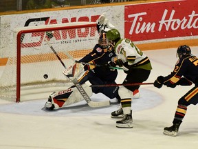The North Bay Battalion's Matvey Petrov is slashed by Nathan Allensen of the visiting Barrie Colts while attacking the net of goaltender Mack Guzda in Ontario Hockey League action Sunday. Allensen was duly penalized on the play, but Barrie won 1-0.
Sean Ryan Photo