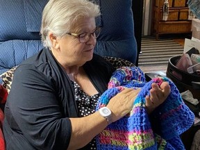 A client of One Care Home and Community Support Services receives hand crocheted blanket made and donated by the Crochet Club of London through the charity’s Gift of Care campaign. (Contributed photo)