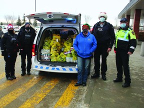 RCMP and community peace officers were at Jeb's No Frills Dec. 11 for the Stuff a Cruiser event in support of the Leduc & District Food Bank. The second annual event also collected donations at Sobeys. (Ted Murphy)
