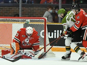 Owen Outwater of the North Bay Battalion, draped by Cameron Peters, threatens goaltender Joseph Costanzo of the visiting Niagara IceDogs in first-period action of their Ontario Hockey League game Thursday night. The Troops visit the Mississauga Steelheads on Friday night.
Sean Ryan Photo