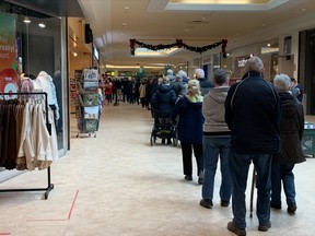 North Bay and area residents wait in line at the COVID-19 pop-up clinic at Northgate Shopping Centre Thursday afternoon. By 1:30 p.m. there were more than 75 people in line waiting for a first or second dose of COVID-19 or a booster shot.