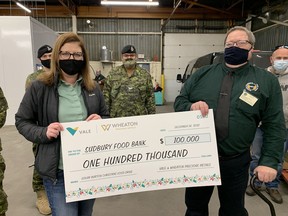 Danica Pagnutti, corporate affairs specialist for Vale’s Ontario Operations, presents a $100,000 cheque in support of the Edgar Burton Christmas Food Drive to Dan Xilon, executive director of the Sudbury Food Bank.