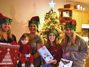Four Stratford and area women are working for the second straight year to ensure local families in need have the gifts and supplies they need for a happy Christmas through their Adopt a Family initiative. Pictured from left are Kate Jacobs, Alyssa McKone, Ashley Jantzi and Emily Griffin. (Galen Simmons/The Beacon Herald)