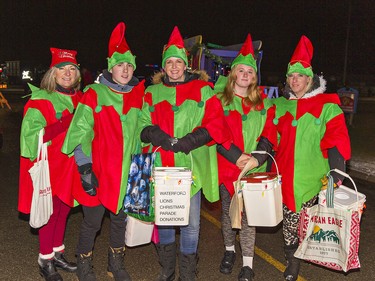 Dressed as elves, volunteers (left to right) Lisa Utley, Blake and Erin Fawcett, Serissa and Loretta Vankruistum collected monetary and food donations along the parade route to benefit the Waterford Food Bank, during the twon's first-ever Santa Claus parade on Saturday December 18, 2021 in Waterford, Ontario. Brian Thompson/Brantford Expositor/Postmedia Network