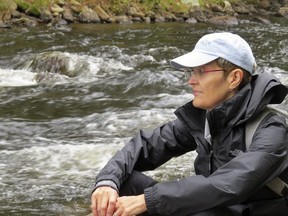 Chatham author Gillian Andrews sits in Algonquin Provincial Park, one of the settings of her new book, Gift of the Loon. (Handout/Postmedia Network)