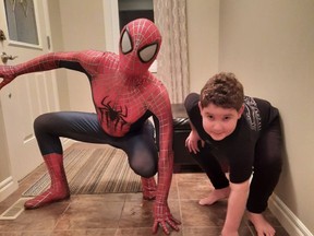 Wyatt Gallant poses alongside Spider-Man, who came to visit in lift his spirits after his brain surgery in September and complications that have followed. Photo courtesy of Mike Loughman and Laurel Gallant