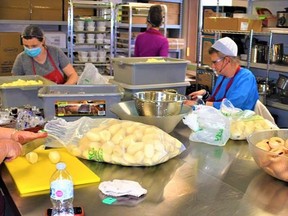 Dedicated volunteers, as shown in 2020, are preparing this week hundreds of traditional holiday meals in the kitchen at the Salvation Army centre on Pinnacle Street in Belleville as part of the charity organization's Christmas dinner Dec. 25. DEREK BALDWIN FILE