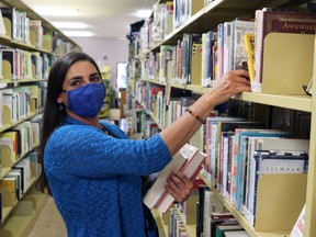 This spring, Library Assistant Lisa Daye shelved some books for patrons to browse at Whitecourt and District Public Library. The library board is asking for a six per cent increase in town funding.