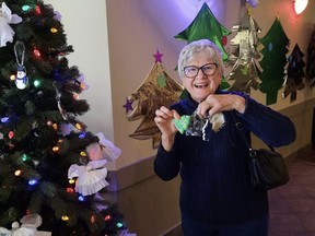 A Southfort Bend resident poses with the decorations provided by Grade 5 students from Southpointe School. Photo Supplied.