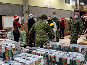 Reservists fill the Christmas hampers from the North Bay Santa Fund, Wednesday, at Canadore College's Commerce Court Campus. More than 600 families will receive hampers and toys for their children Thursday.
PJ Wilson/The Nugget