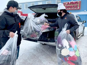 The Timmins Rock, in conjunction with Soucie Salo Safety, collected toques, mittens, scarves and socks during the NOJHL squad’s final home game before Christmas at the McIntyre Arena on Sunday. Members of the team, including, Gabinien Kioki, left, and Riley Brousseau were on hand Wednesday to present the items to Living Space. PHOTO COURTESY KINZ AND KLOMP LIVE