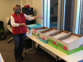 Strathcona Christmas Bureau board member Betty Barr, with the one morning's worth of envelopes. This year, the organization broke a record by helping 500 families. Photo Supplied
