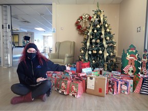 Jennifer Mahoney sits next to some of the 102 gifts that were bought as part of HKS Security’s Adopt A Senior campaign. Mahoney and HKS dropped the gifts off at the Salem Manor seniors home on December 17, 2021