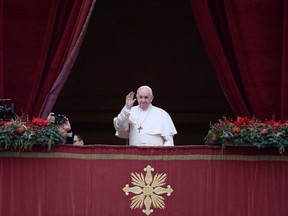 Pope Francis greets the gathered faithful during his Christmas Urbi et Orbi blessing in St. Peter's Square at The Vatican on Saturday. (Photo by FILIPPO MONTEFORTE/AFP via Getty Images)