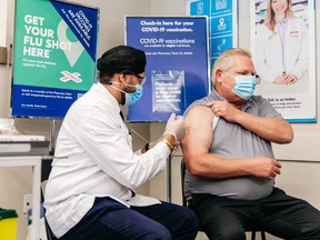 Premier Doug Ford is shown receiving his COVID-19 booster dose at an Etobicoke pharmacy earlier joining millions of Ontarians who have received their third shot to combat the spread of the latest Omicron variant.
