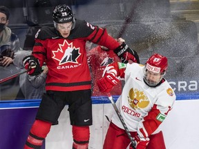 Soo Greyhounds defenceman Ryan O’Rourke (28) is checked by Russia's Matvey Michkov (17) during first period IIHF World Junior Hockey Championship exhibition action in Edmonton, Thursday, Dec. 23, 2021.