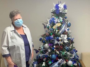 Gail Sheppard trims the Suomi Eesti Maja lobby with decorations, some of which she has collected over many years.