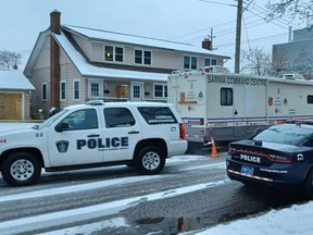 Sarnia police vehicles, including the command post, are shown parked Wednesday morning on Watson Street, at the corner of London Road.