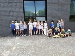 On Wednesday, June 2, Heritage Hills Elementary's Mrs. Wujcik's Grade 2 class etched 215 chalk hearts outside of the school to honour the 215 children's unmarked graves found at a former Kamloops Residential School. Photo courtesy Twitter/@Amanda26894232