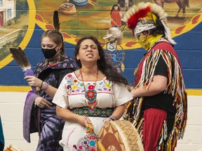 Yessica Rivera Belsham sings Tonantzin, a song in the Nahuatl language, while family members dance around her in traditional clothing during the Indigenous Peoples Day event on Monday, June 21. (JESSICA MUNRO/Local Journalism Initiative Reporter)