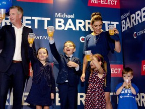 Conservative MP-elect Michael Barrett and his family raise their glasses towards the crowd of supporters at Luna Pizzeria after Barrett was re-elected in the local riding shortly after 10:30 p.m. on Monday, Sept. 20. (JESSICA MUNRO/Local Journalism Initiative Reporter)
