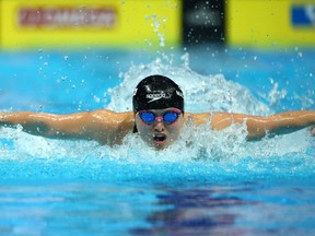 Margaret MacNeil of Canada competes in the Women's 100m Butterfly. (Photo by Francois Nel/Getty Images)