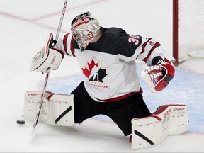 Team Canada goalie Brett Brochu makes a save against Team Austria during the second period of their IIHF world junior hockey championship round-robin game in Edmonton on Tuesday, Dec. 28, 2021. Photo by David Bloom
