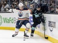 Edmonton Oilers' Seth Griffith (23) and Seattle Kraken's Morgan Geekie (67) battle for the puck during the second period at Climate Pledge Arena in Seattle, Wash., on Dec. 18, 2021. (Stephen Brashear-USA TODAY Sports)