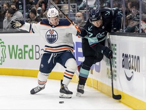 Edmonton Oilers' Seth Griffith (23) and Seattle Kraken's Morgan Geekie (67) battle for the puck during the second period at Climate Pledge Arena in Seattle, Wash., on Dec. 18, 2021. (Stephen Brashear-USA TODAY Sports)