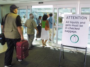 Travellers enter Terminal 3 at Pearson International Airport departure area.
